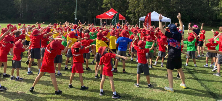 Students doing warm up exercises before the Cross Country Carnival
