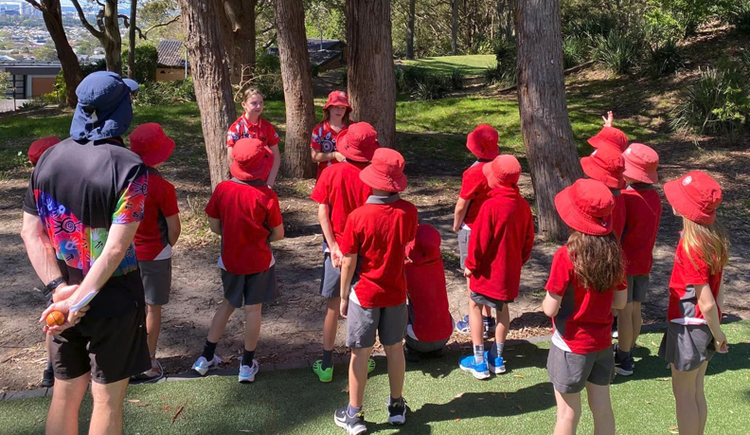 Photo of students and teacher in playground.
